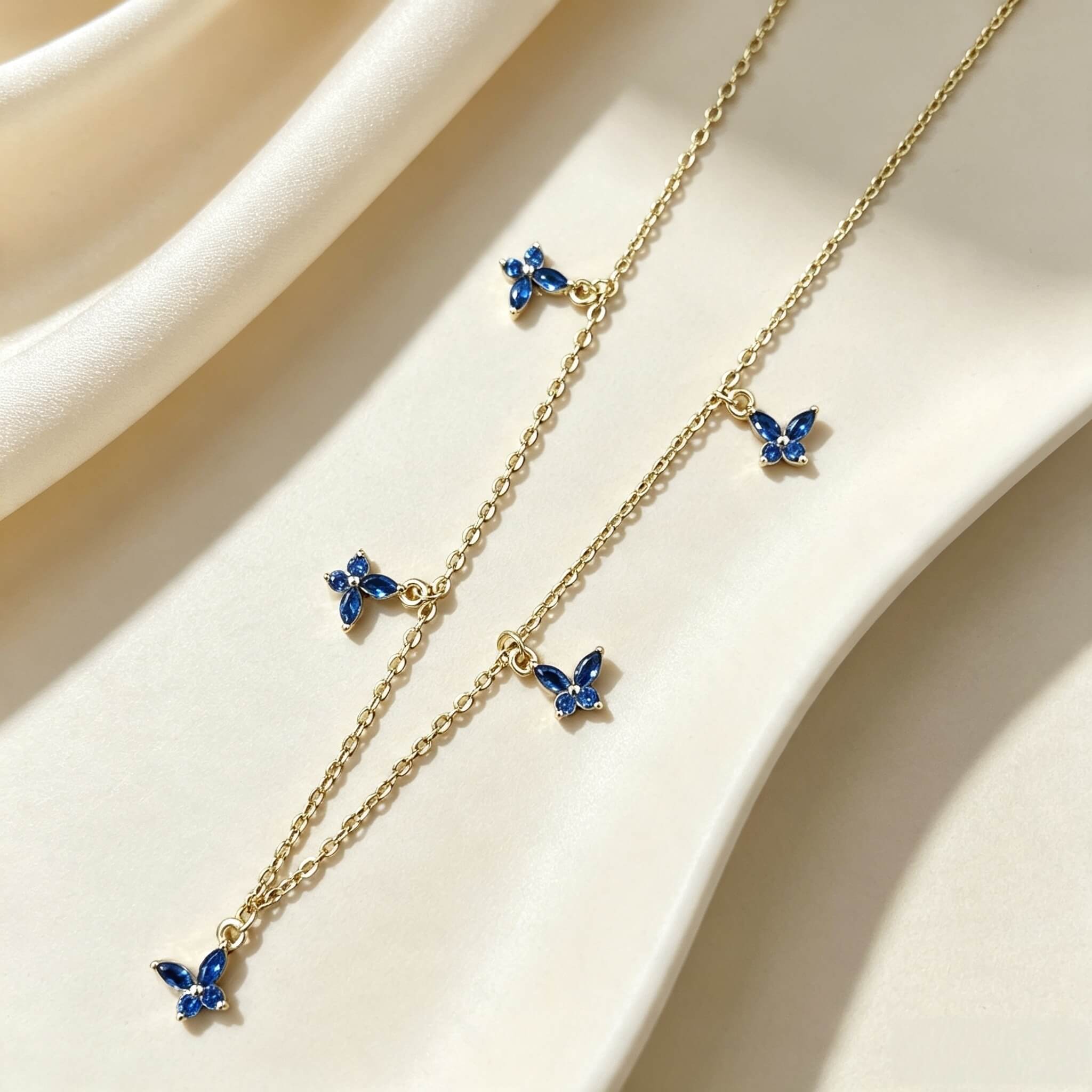 S925 sterling silver 14K gold plated butterfly necklace with marquise‑cut blue spinel and cubic zirconia five butterfly charms