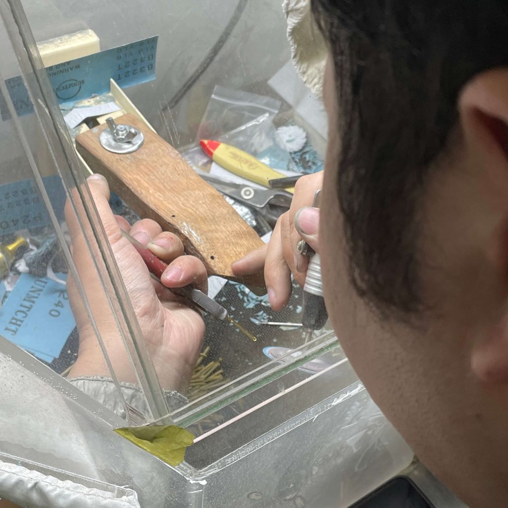 Jewelry craftsman performs mold‑finishing for S925 sterling silver jewelry in workshop