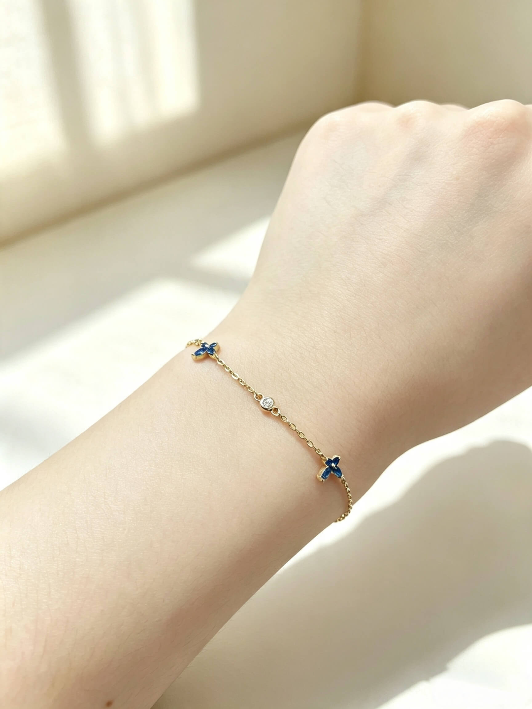 Wrist wearing marquise‑cut blue spinel butterfly S925 sterling silver bracelet