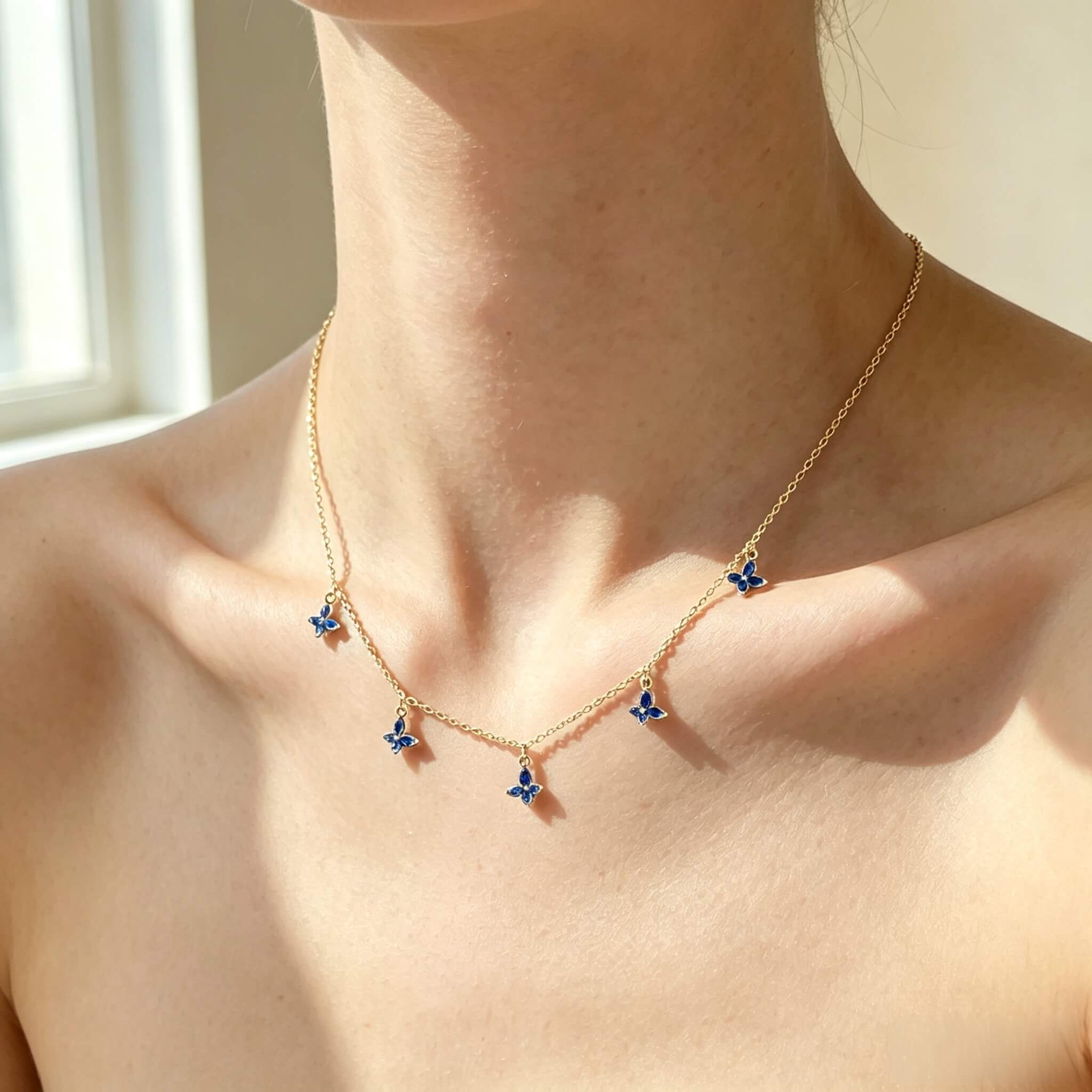 Woman wearing marquise‑cut blue spinel butterfly S925 sterling silver necklace
