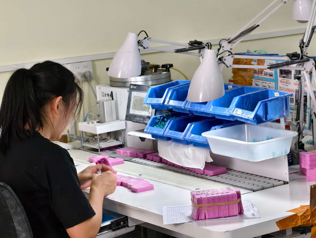 Worker performing wax injection for jewelry production